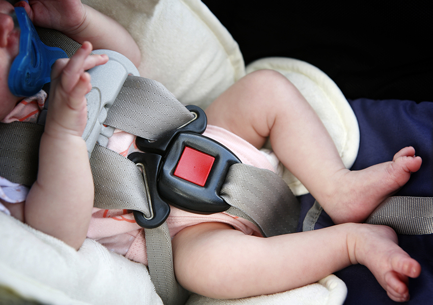 Baby in car-seat bucked up.