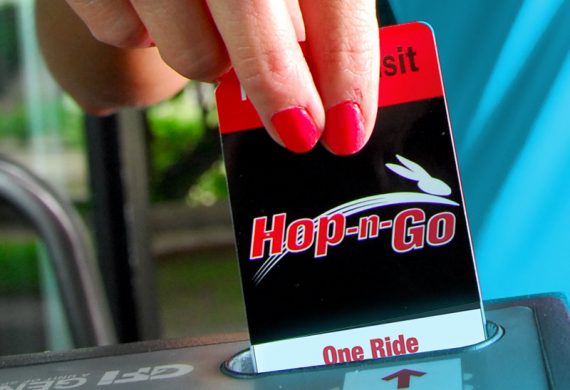 image of a hand inserting a Hop-N-Go pass into the farebox