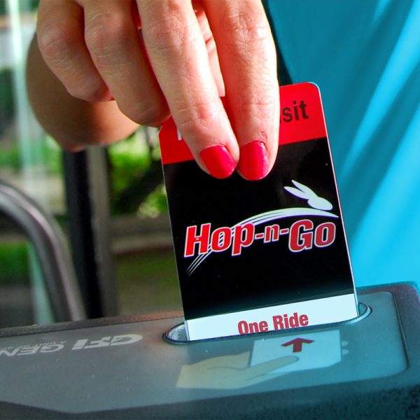 image of a hand inserting a Hop-N-Go pass into the farebox