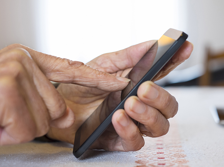 Senior woman Using mobile phone at home