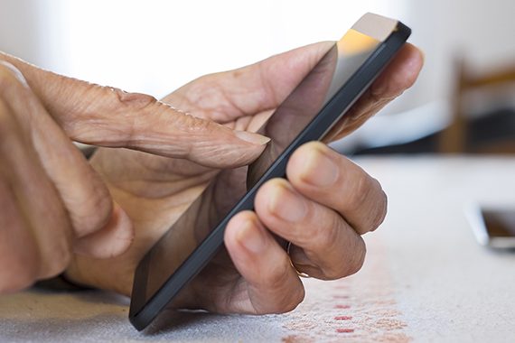 Senior woman Using mobile phone at home