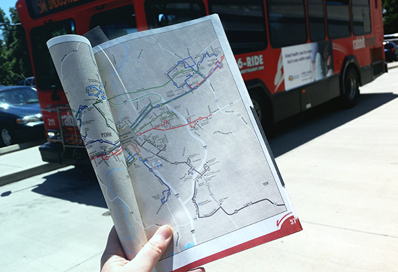 hand holding a rider guide folded open to a map