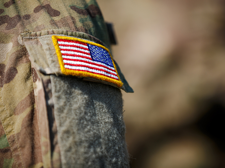 USA flag and US Army patch on solder's uniform